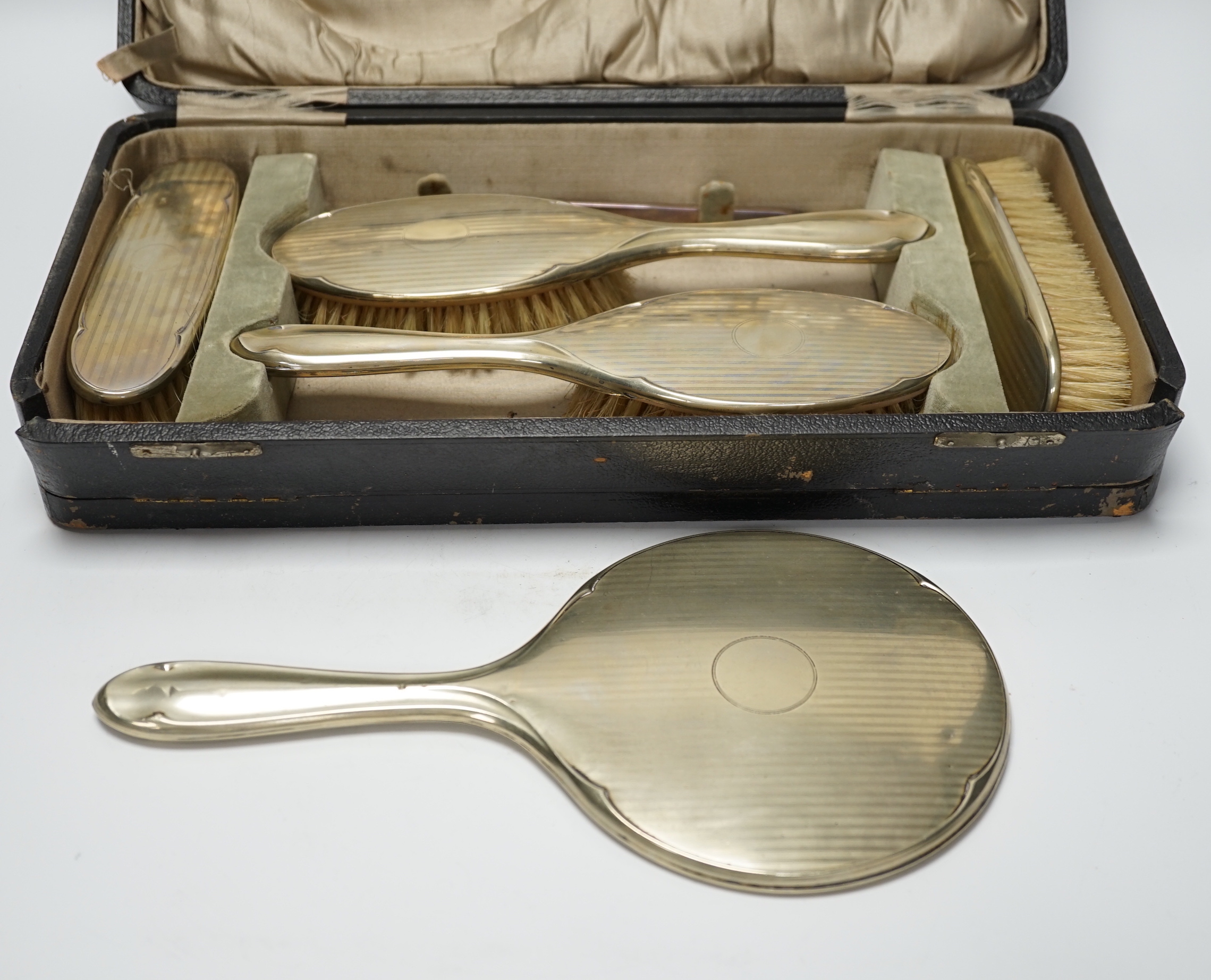 A cased 1930's six piece plated mirror and brush set.